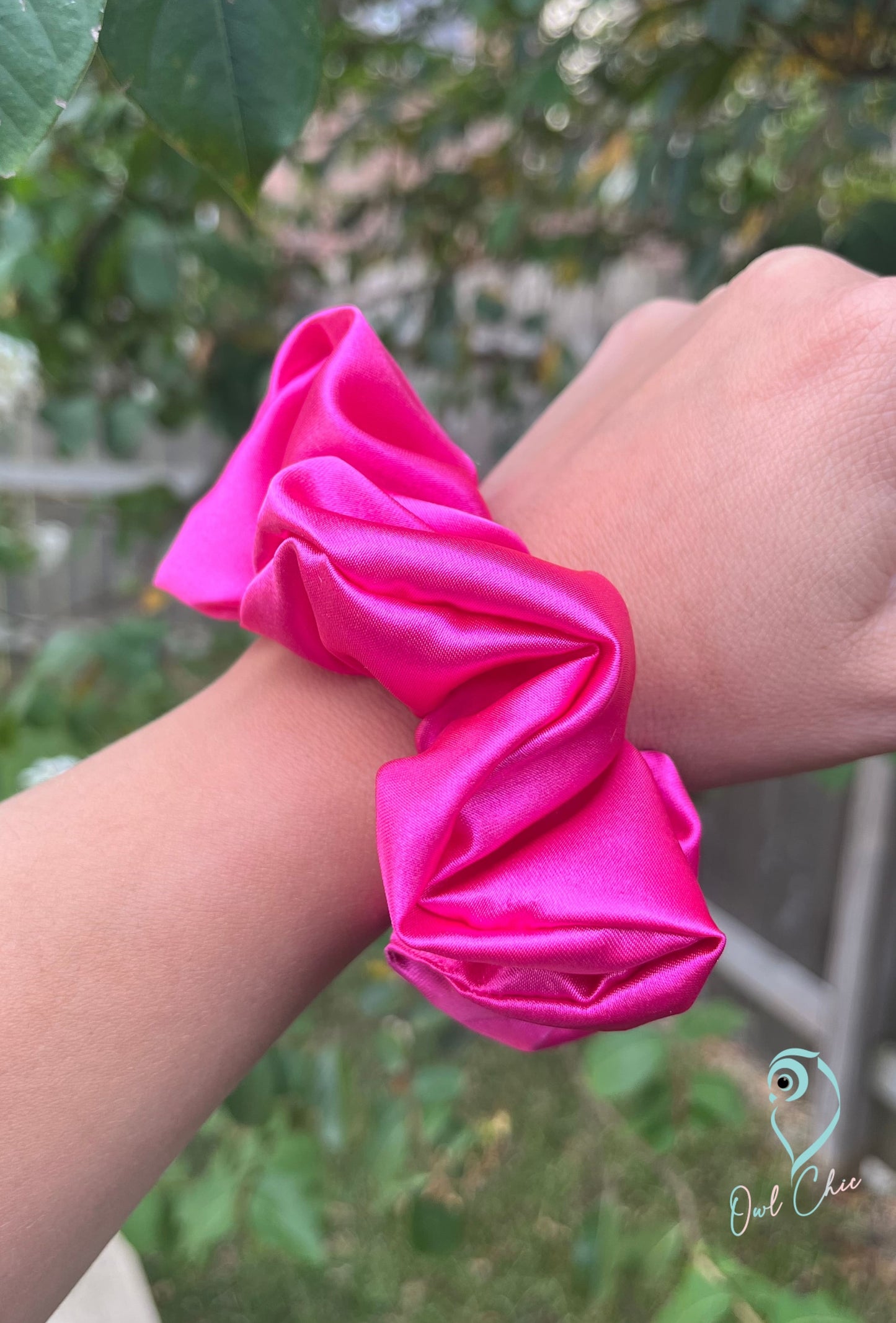 Polyester charmeuse satin scrunchie in hot pink.