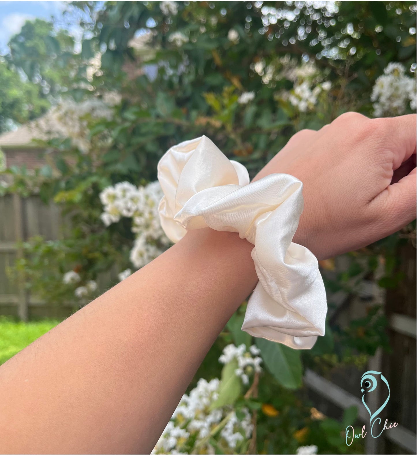 Polyester charmeuse satin scrunchie in white cream.