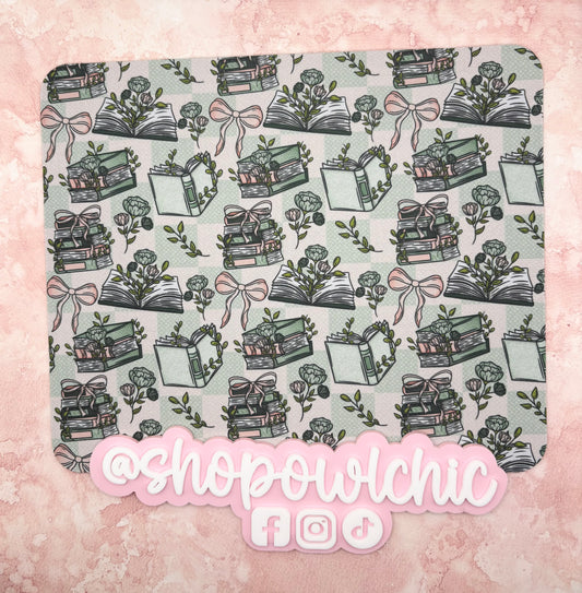 Mouse pad with book and bow pattern on a pink background, featuring the brand 'shopowlchic'.